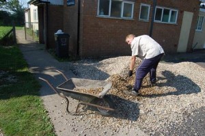 It was all going on at the shack and village hall today.  Steve levelling the gravel - Copy